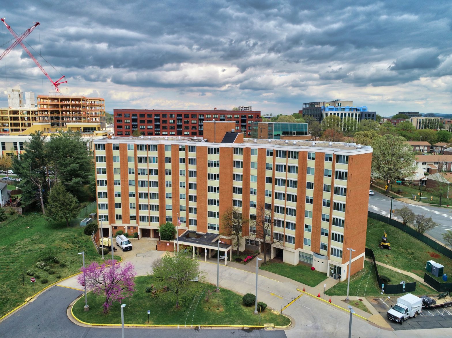 Exterior photo Crescent Halls, an eight-story tall tan apartment building with 105 units