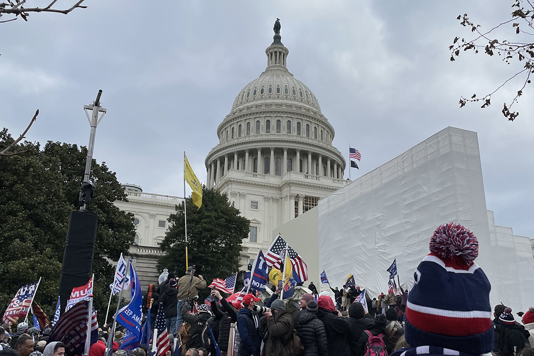 Capitol rioters hold Trump flags near Capitol building