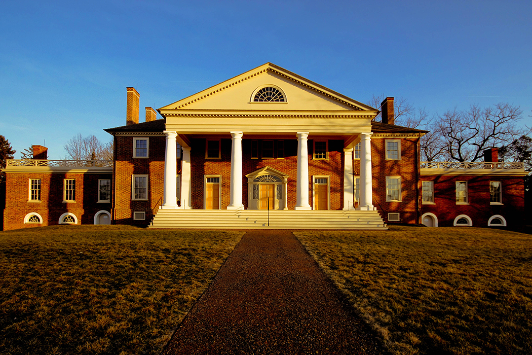 front view of Montpelier during sunset showing four white columns topped by triangle archway