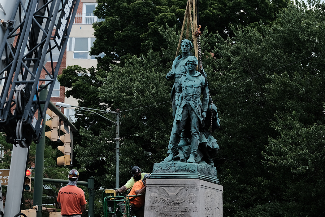 Lewis Clark and Sacajawea statue about to be lifted in the air by a crane