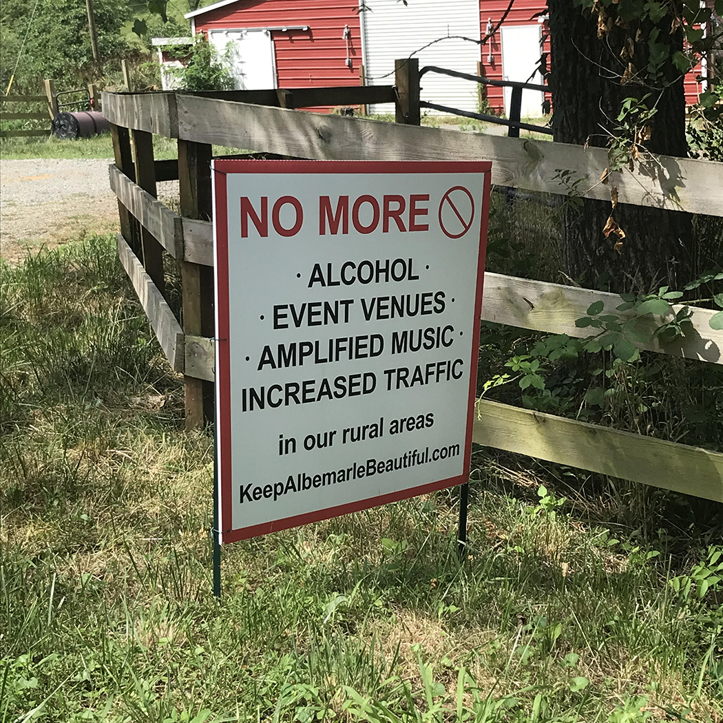 Sign with bold letters that reads “NO MORE ALCOHOL, EVENT VENUES, AMPLIFIED MUSIC, INCREASED TRAFFIC IN OUR RURAL AREAS. KEEP ALBEMARLE BEAUTIFUL.”