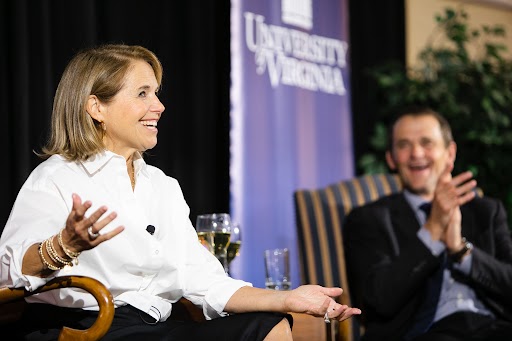 Journalist Katie Couric sitting in a chair next to UVA president Jim Ryan