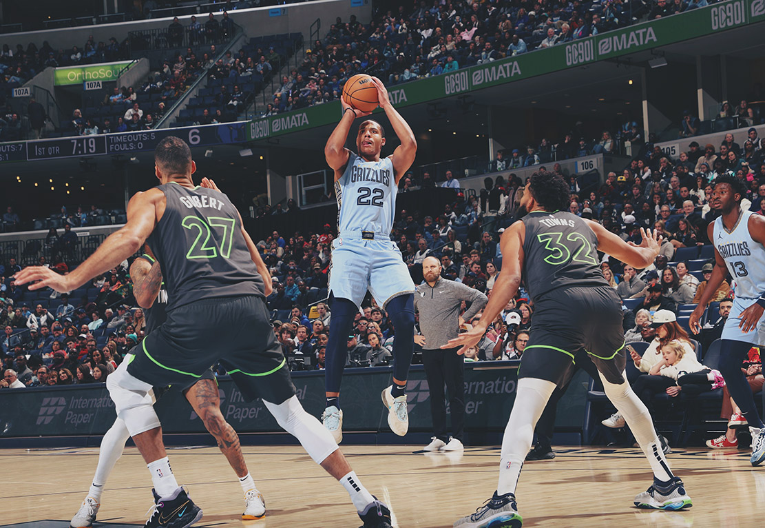 Desmond Bane takes a contested shot over Rudy Gobert and Karl Anthony Towns.