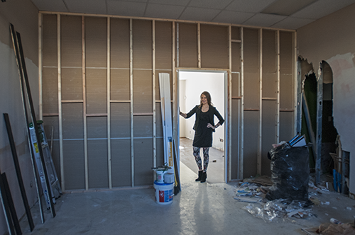 Alexandra stands in the doorway connecting The Cedar Room to Pageboy Salon.