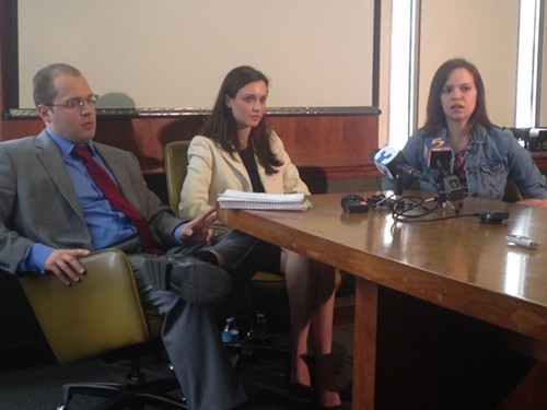 Attorney Daniel Lofton, left, talks to the media with his clients, Meaghan Ybos, center, and Madison Graves, right.