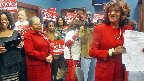 Brooks beams after filing as backer Ruby Wharton looks on.