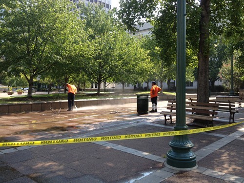 City crews clean up the sidewalk that Occupy has inhabited for nearly one year.