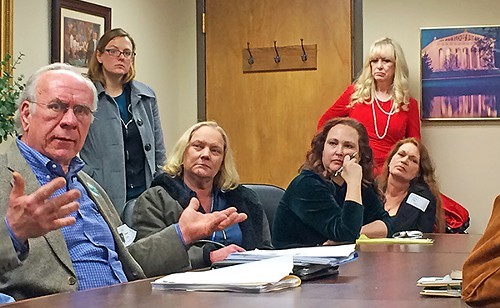 Ellis and Jones (in red,standing) counsel Koozer-Kuhn supporters after last week's hearing in Nashville