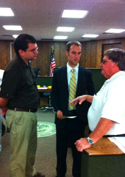 Guerrero (left) discusses the case with his attorney DeBoard (center) and code enforcement officer Byron Jamison (right)