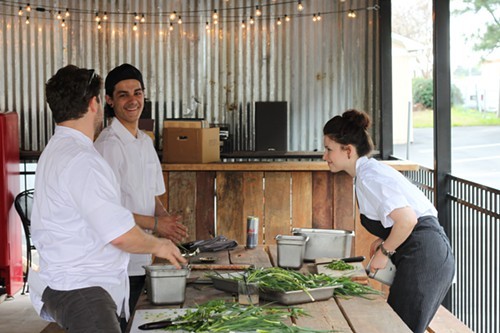 Hog & Hominy staff preparing for chefs meal after Beard dinner. H&H is converting its back patio, shown here, into a dive bar.