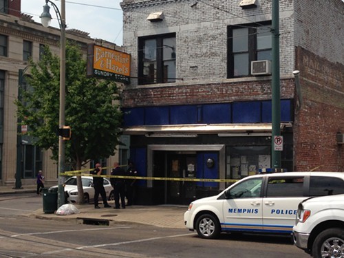 Memphis Police Officers stand outside a roped-off Earnestine and Hazels.