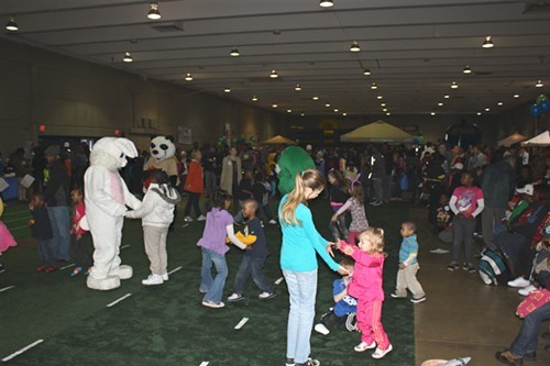 More children dancing on the makeshift lawn in the Plipkin Building. The Easter Egg Roll was moved inside due to inclement weather.