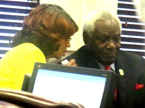 Ousted Commissioner Henri Brooks consults with Commission ally Walter Bailey on Wednesday