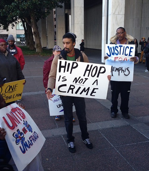 Protesters gather outside of City Hall with messages for police.