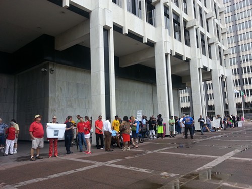 Protesters in front of City Hall say theyre angry about the city councils recent cuts to employee benefits.