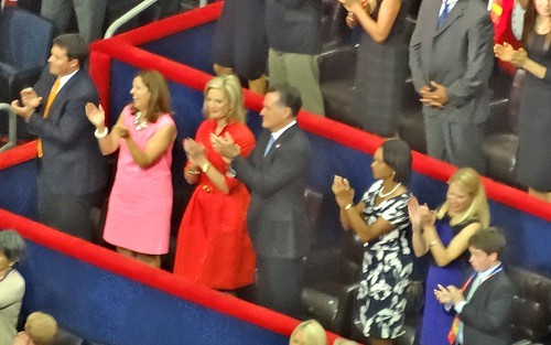 Romney applauds a Christie line during his Tuesday night sojourn in the arena