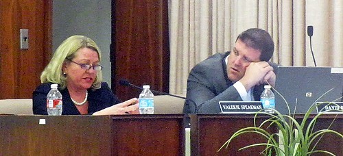 SCS attorney Valerie Speakman reads terms of agreement with Lakeland as board member David Reaves, who moved to accept it, listens.