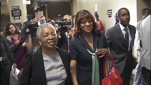 Still wearing the same odd smile she had when turning herself in Thursday night, Brooks, accompanied by an unidentified supporter (left) and her attorney, Andre Wharton, prepared to enter the courtroom of General Sessions Judge Bill Anderson, Jr.